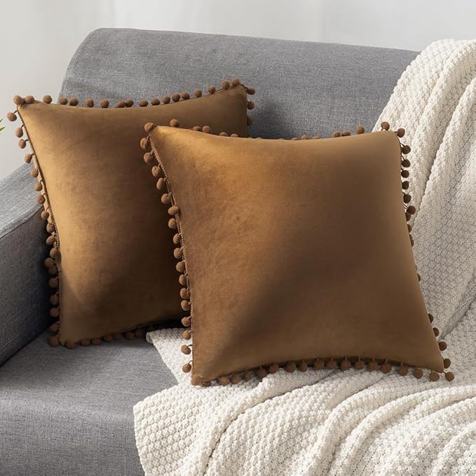 DEZENE Throw Pillow Covers with Pom-poms, 2 Pack Super Soft Velvet Decorative Pillow Cases, Square Cushion Covers Pillowcases for Farmhouse,Couch,Sofa, 24x24 Inch, Golden Brown